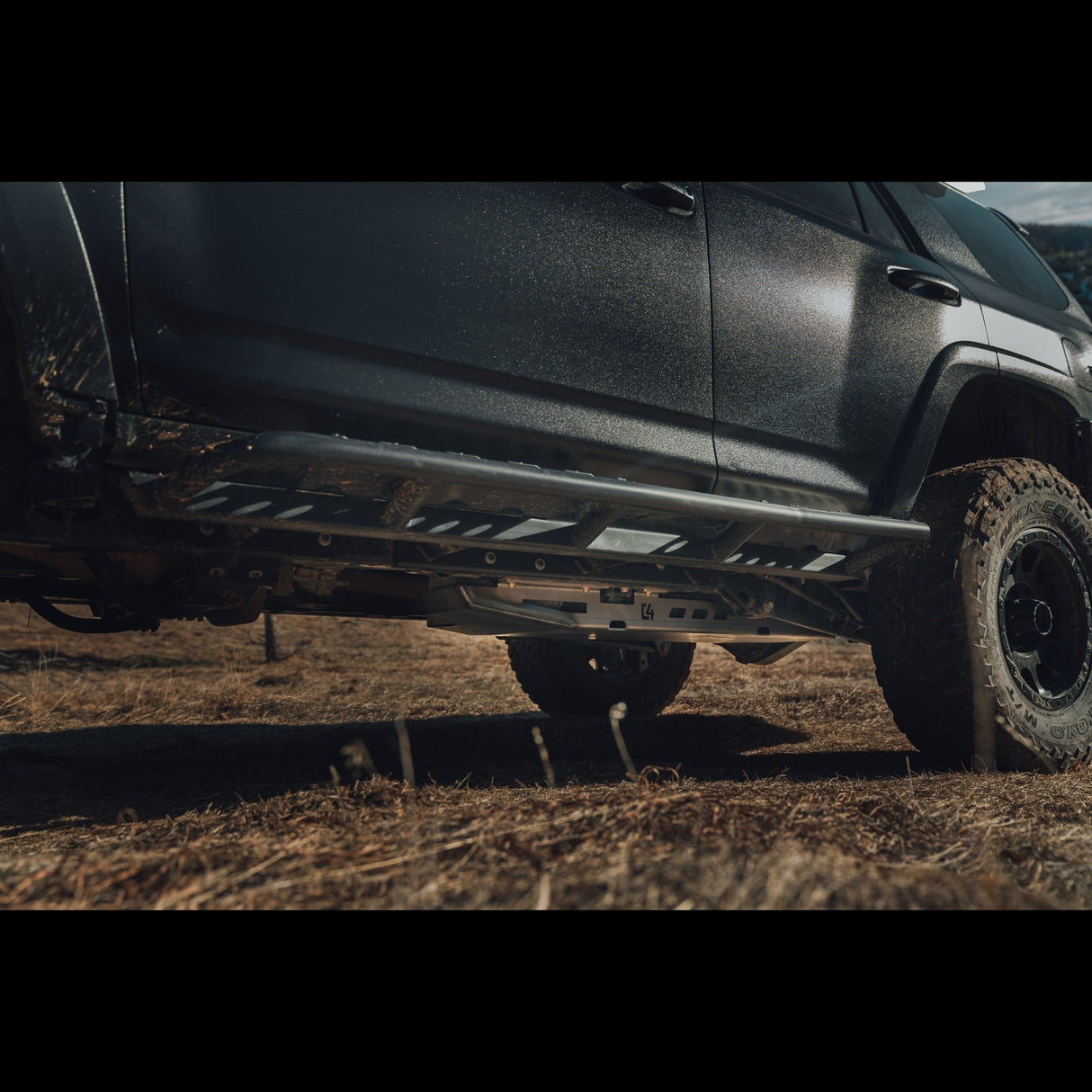 C4 Fabrication fuel tank skid plate on a 4Runner (5th Gen) with rock sliders